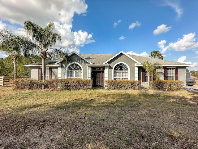 single story home featuring a front lawn