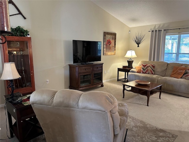 carpeted living room featuring vaulted ceiling and a textured ceiling