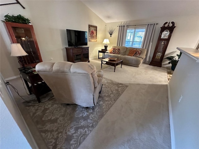 carpeted living room featuring vaulted ceiling