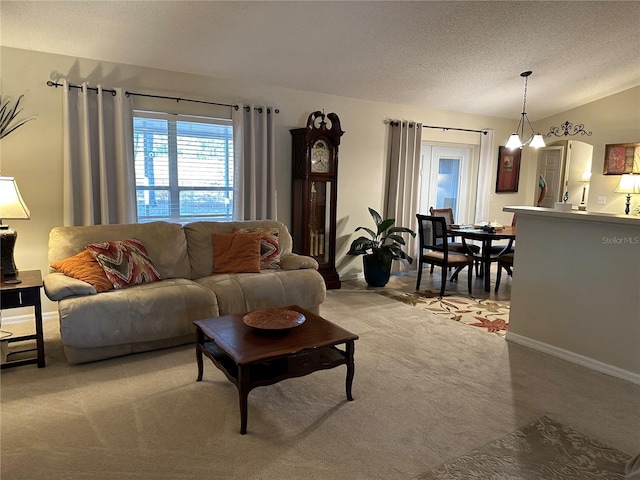 carpeted living room featuring vaulted ceiling and a textured ceiling