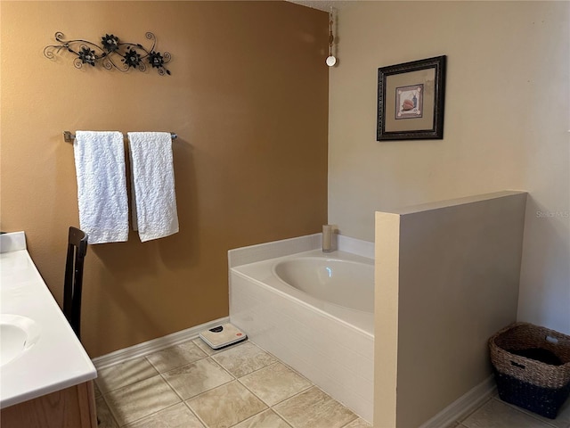 bathroom with vanity, tile patterned flooring, and a washtub