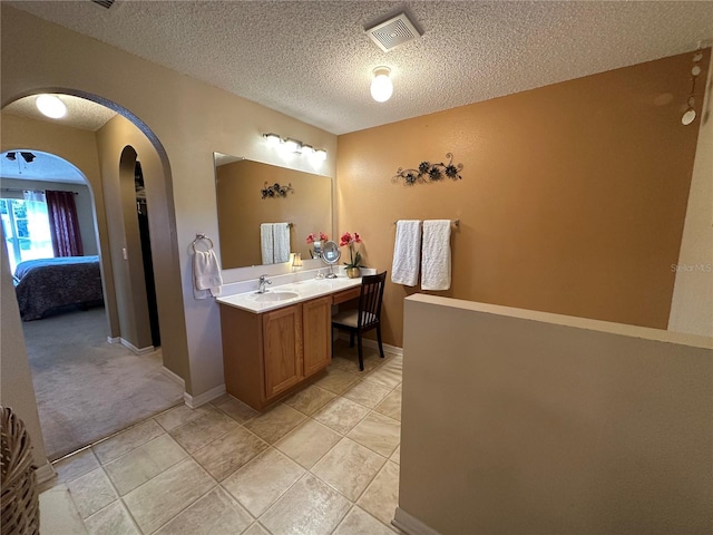 bathroom with vanity and a textured ceiling