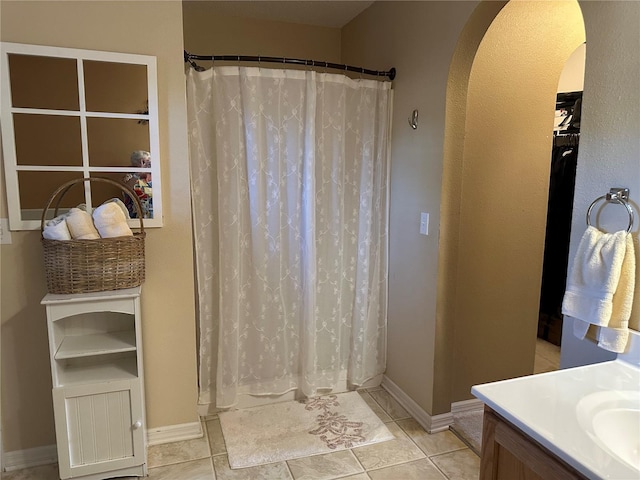 bathroom featuring tile patterned flooring, vanity, and a shower with curtain