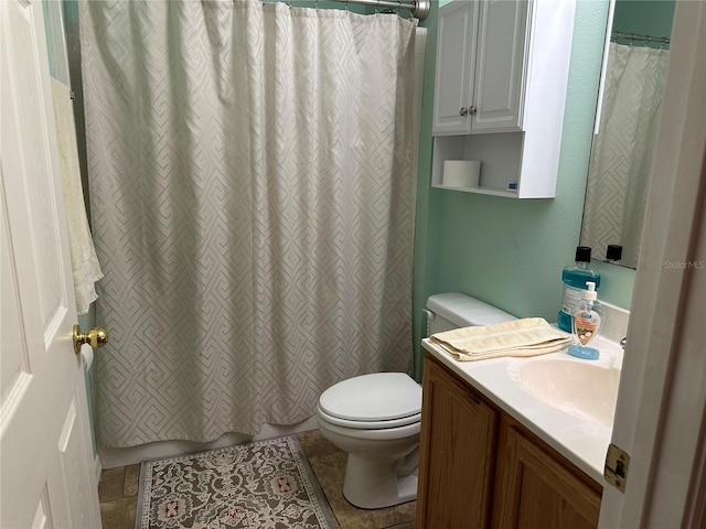 bathroom featuring vanity, toilet, curtained shower, and tile patterned flooring