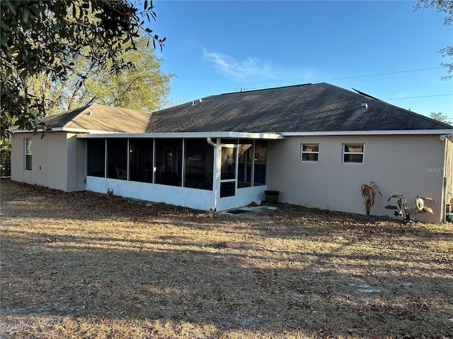 rear view of property with a sunroom