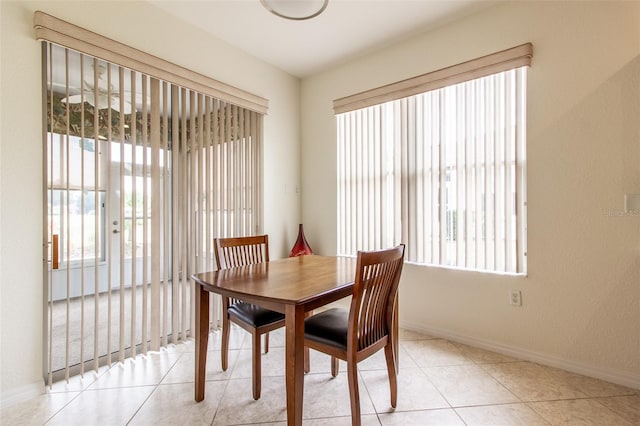 dining area featuring light tile patterned floors and plenty of natural light