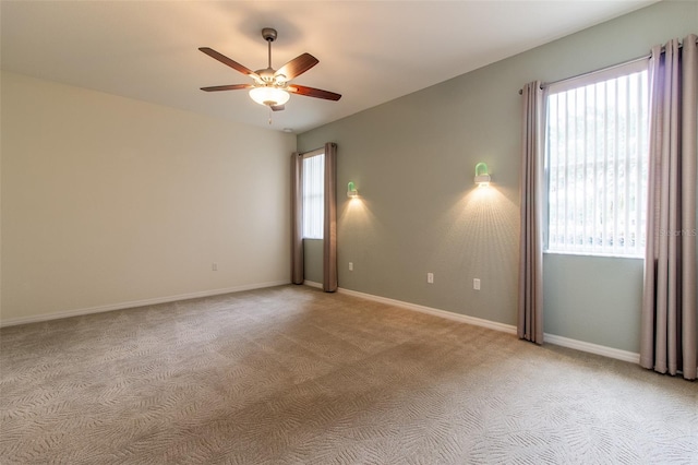 carpeted empty room featuring ceiling fan