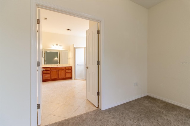 hallway with light tile patterned floors