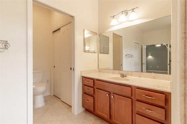 bathroom with vanity, toilet, and tile patterned flooring