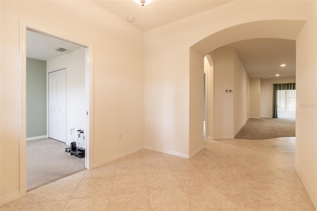 corridor with light colored carpet