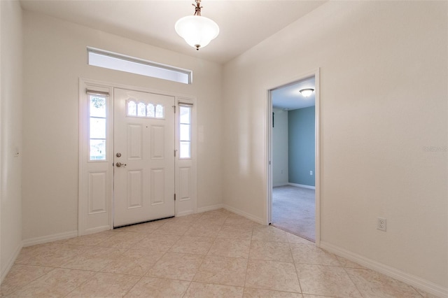 foyer entrance with light tile patterned flooring