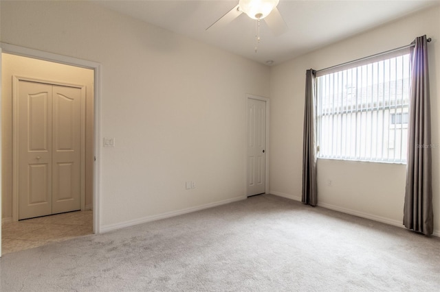 spare room with light carpet and ceiling fan