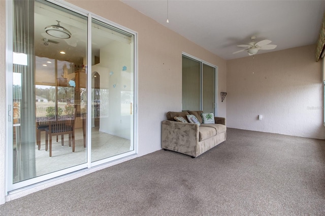 unfurnished room featuring ceiling fan and carpet floors