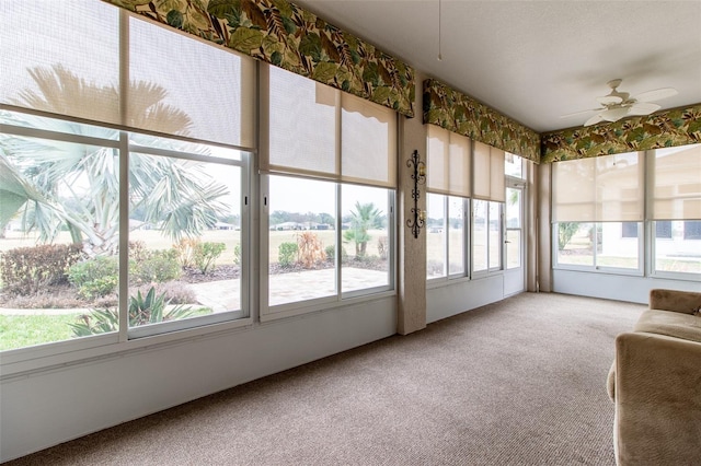 unfurnished sunroom featuring ceiling fan