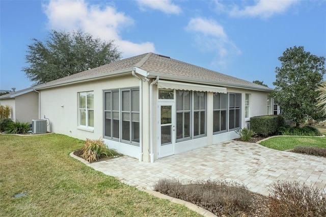 back of house featuring a yard and central AC