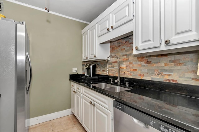 kitchen featuring white cabinetry, sink, light tile patterned flooring, and appliances with stainless steel finishes