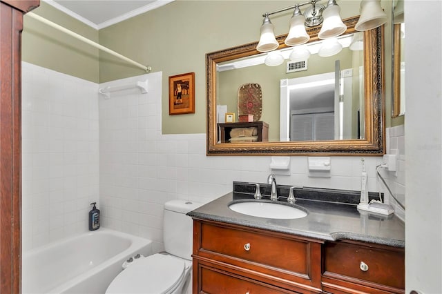 full bathroom featuring toilet, tiled shower / bath, tile walls, ornamental molding, and vanity