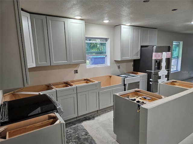 kitchen featuring a textured ceiling and appliances with stainless steel finishes