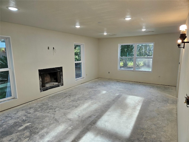 unfurnished living room featuring concrete flooring