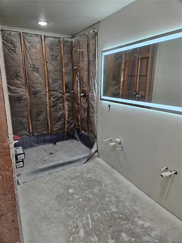 bathroom with a textured ceiling