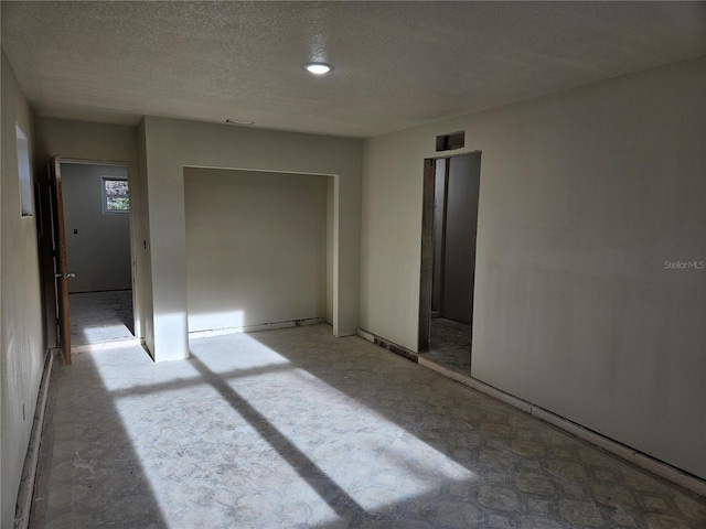 spare room featuring a textured ceiling