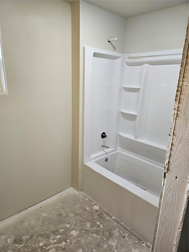 bathroom featuring bathing tub / shower combination and concrete floors