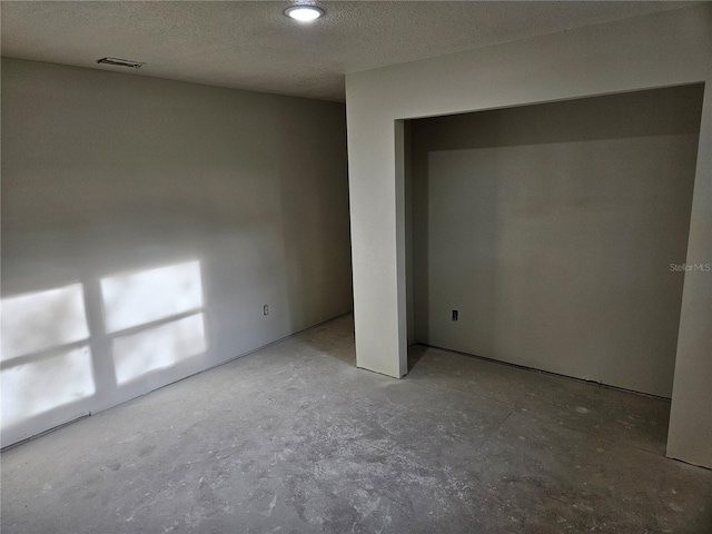 unfurnished bedroom with a textured ceiling