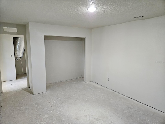 unfurnished bedroom featuring a closet and a textured ceiling