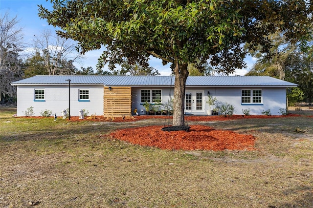 ranch-style house with french doors and a front yard