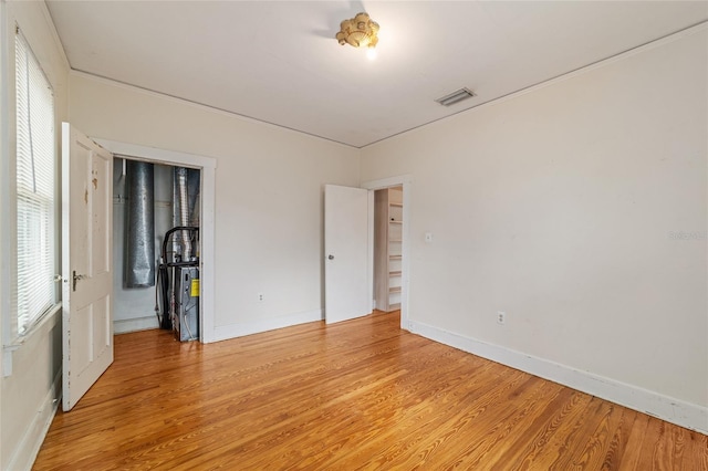 unfurnished room with plenty of natural light and light hardwood / wood-style floors