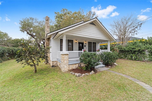 bungalow-style house with a porch and a front lawn