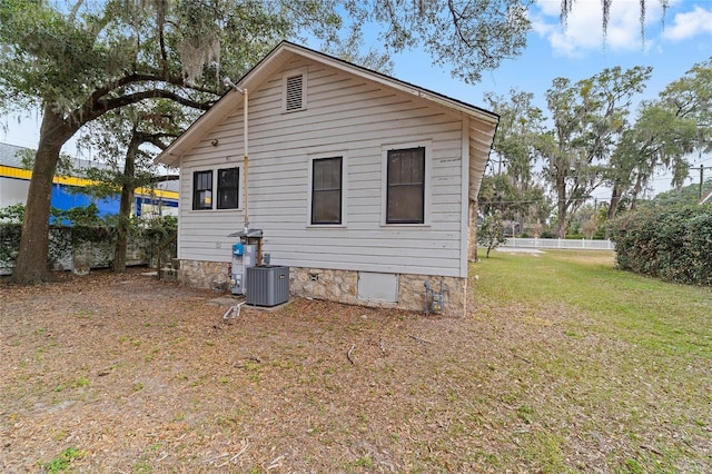 back of property featuring a yard and cooling unit