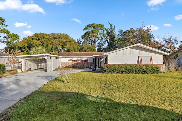 ranch-style home with a front yard and a carport