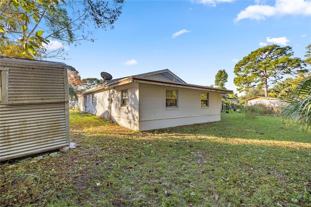 view of side of property with a lawn