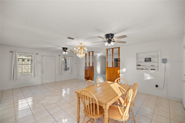 dining area featuring ceiling fan with notable chandelier, light tile patterned floors, and built in features