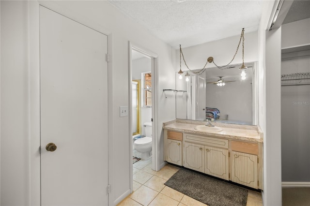 bathroom with vanity, tile patterned floors, a textured ceiling, and toilet