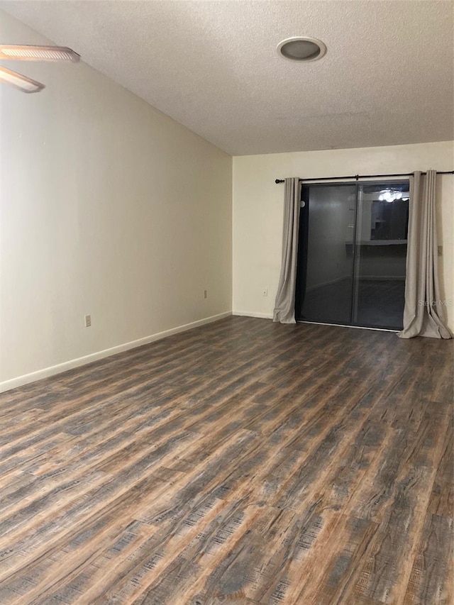 spare room with dark hardwood / wood-style flooring and a textured ceiling