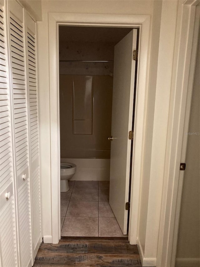 bathroom with toilet and tile patterned flooring