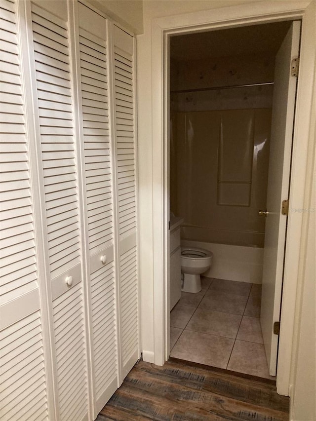 bathroom with toilet and tile patterned flooring