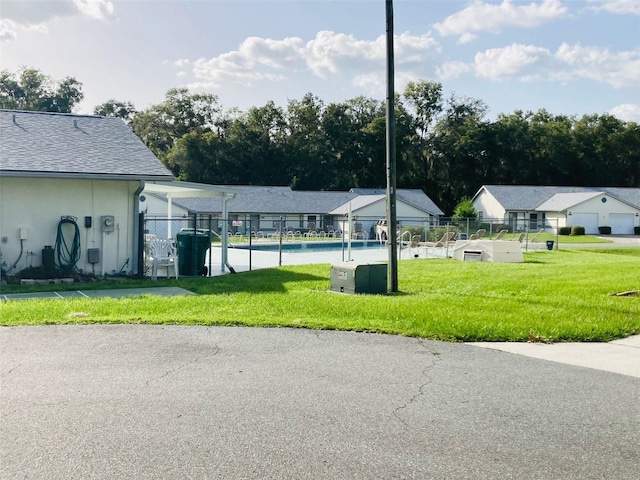 view of swimming pool with a yard