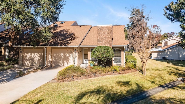 view of front of home with a garage and a front yard