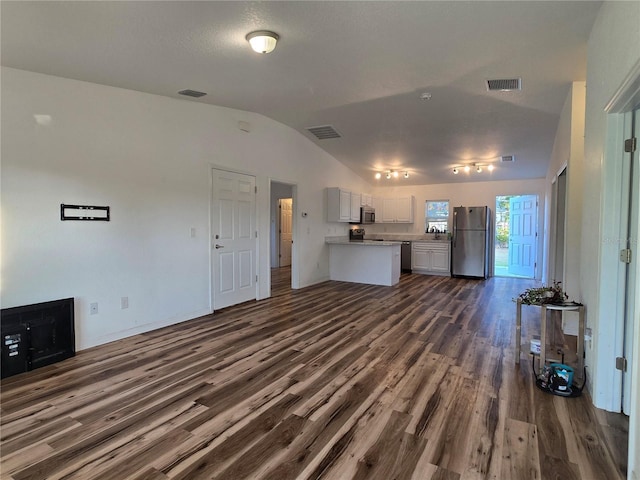 unfurnished living room featuring lofted ceiling, dark hardwood / wood-style flooring, and sink