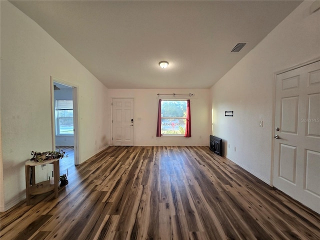 unfurnished living room with dark hardwood / wood-style flooring and vaulted ceiling