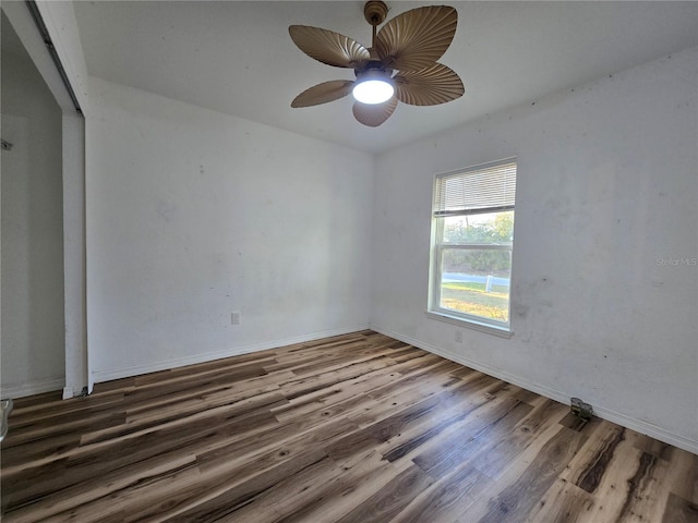 spare room with ceiling fan and dark hardwood / wood-style flooring