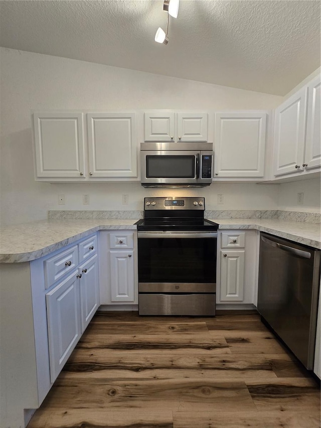 kitchen featuring white cabinetry, appliances with stainless steel finishes, and dark hardwood / wood-style flooring