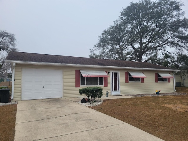 single story home with a garage and a front lawn