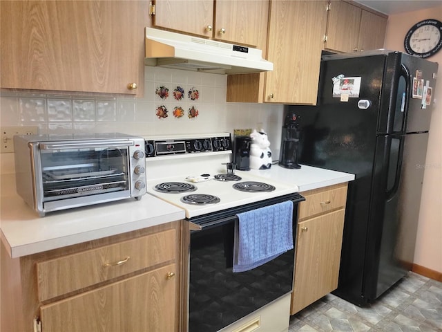 kitchen with tasteful backsplash, electric range oven, and black refrigerator