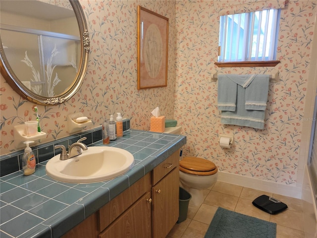 bathroom featuring vanity, toilet, and tile patterned flooring