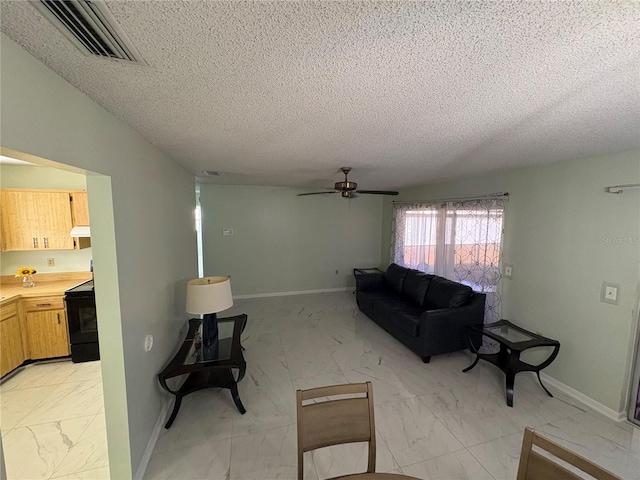 living room featuring ceiling fan and a textured ceiling