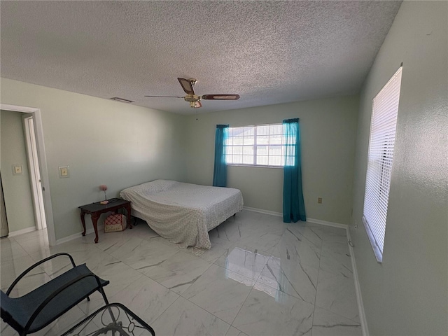 bedroom featuring a textured ceiling and ceiling fan